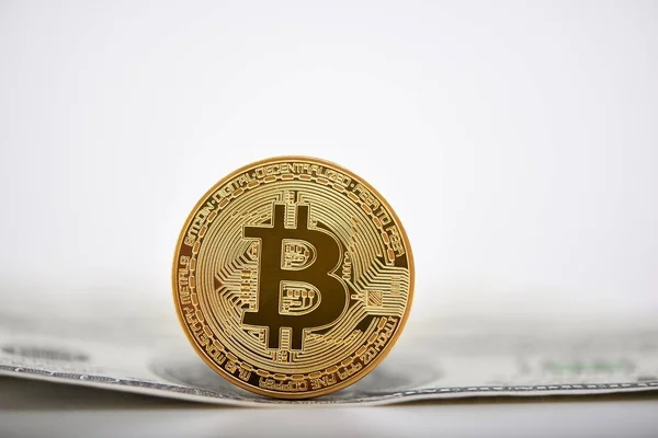 Golden bitcoin presented on a dollar banknote as the most important cryptocurrency worldwide. — Stock Photo, Image