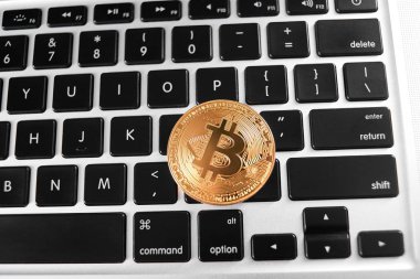 Laptop klavye üzerinde yerleştirilen Dünya ana cryptocurrency olarak bir altın bitcoin