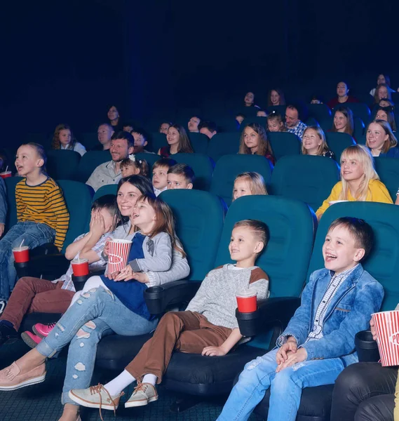 Sideview of happy children watching movie. — Stock Photo, Image