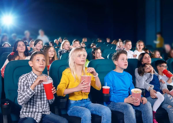 Frontview of schoolmates watching movie in cinema — Stock Photo, Image