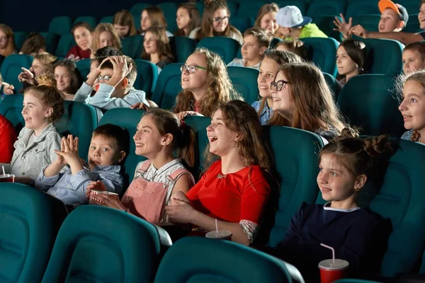 Sideview of laughing children in the cinema. — Stock Photo, Image