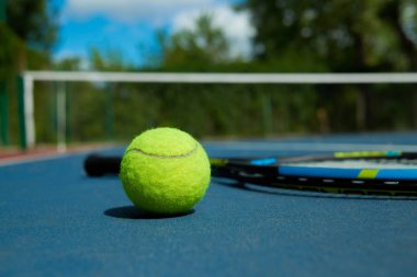 Tenis raketi zemin üzerine sarı top yakın çekim.
