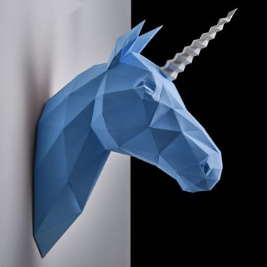 Blue unicorns head hanging on the contrast white and black wall. clipart