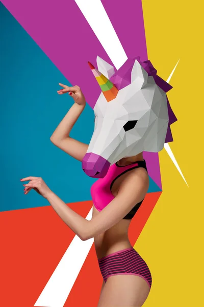 Slim model wearing colorful unicorns head. — Stock Photo, Image