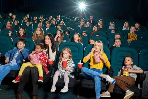 Frontview, érzelmi felnőttek és a gyermekek az új mozi film nézés. — Stock Fotó