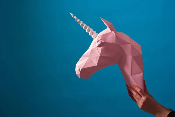 Pink paper unicorns head on blue background. — Stock Photo, Image