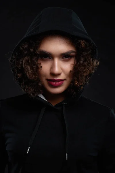 Curly girl wearing black hood