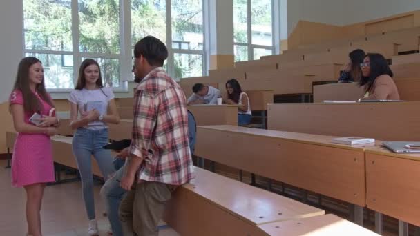 Different nationalities students communicating in classroom. — Stock Video