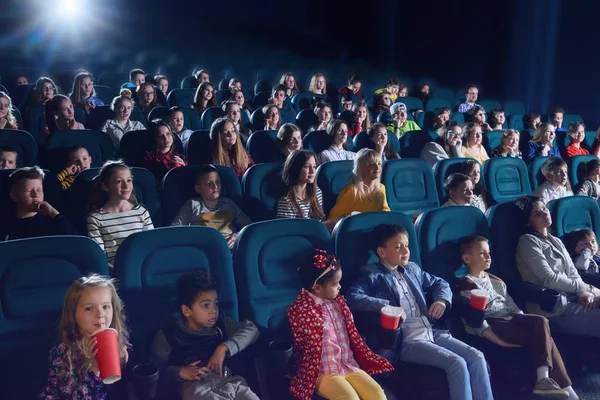 Spectators enjoying film in modern movie theatre. — Stock Photo, Image