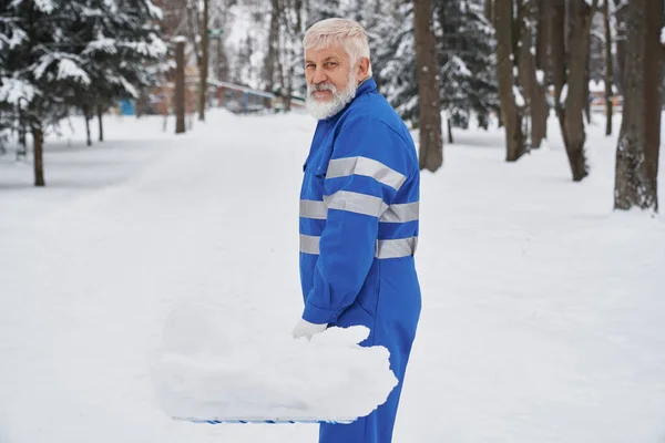 Portret sprzątaczki w kombinezonie ze śnieżnym shover. — Zdjęcie stockowe