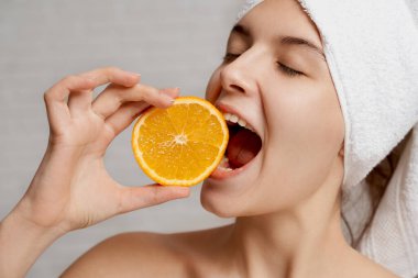 Close up of positve model holding orange and biting. clipart