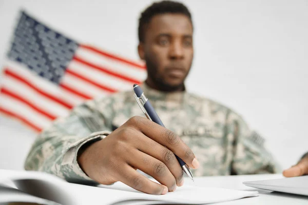 Hombre soldado mano celebración pluma y escritura documento . — Foto de Stock