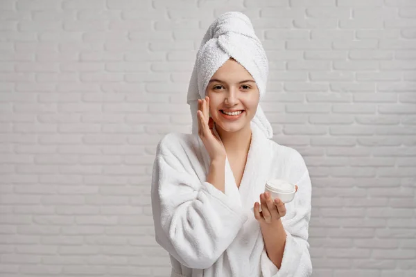 Girl in white dressing gown and towel caring about skin — Stock Photo, Image
