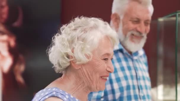 Усміхнена зріла леді і бородатий чоловік купує розкішні прикраси — стокове відео