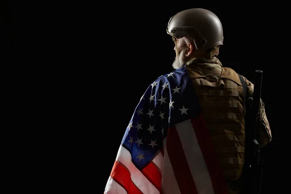 Visão traseira do veterano americano com bandeira e rifle . — Fotografia de Stock