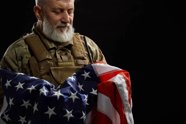 Veterano de uniforme militar segurando bandeira americana . — Fotografia de Stock