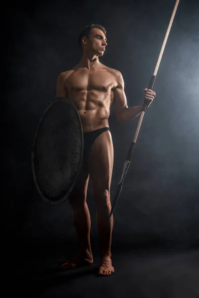 Young warrior holding spear and shield. — Stock Photo, Image