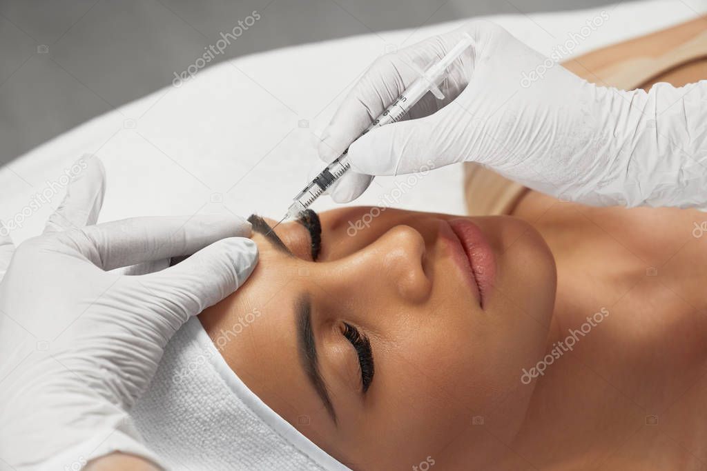Cosmetic botox injection in forehead.