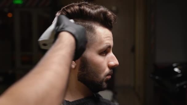 Portrait of handsome man changing hairstyle at barbershop — Stock Video