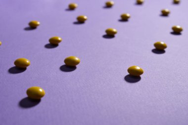 Chocolate peanut candies in yellow sugar shell.