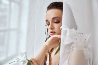 Elinde zambak çiçeği tutan kızın portresi.