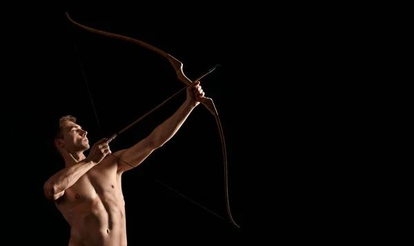 Athletic archer shooting with bow. — Stock Photo, Image