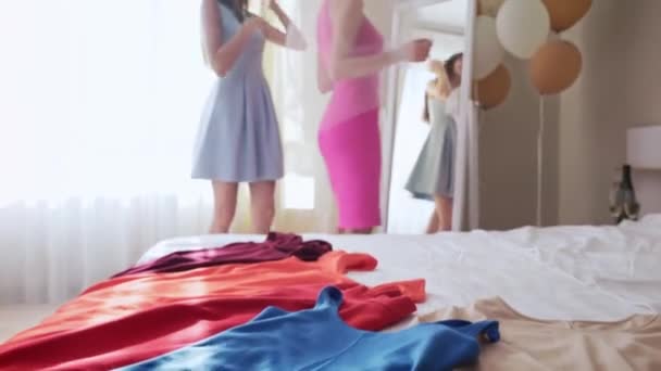 Happy bride with her bridesmaid trying on stylish dresses — 비디오