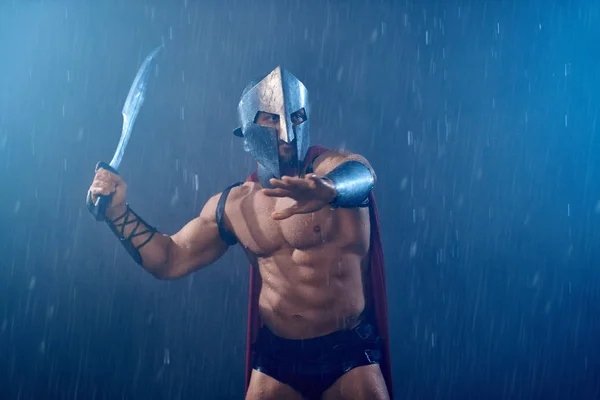 Muscular spartan with sword. — Stock Photo, Image