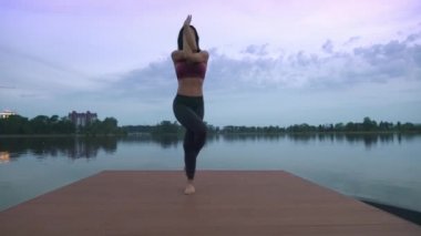 İskelede yoga yaparken kadın.