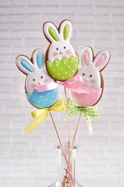 Group of three easter bunny cookies on stick in vase