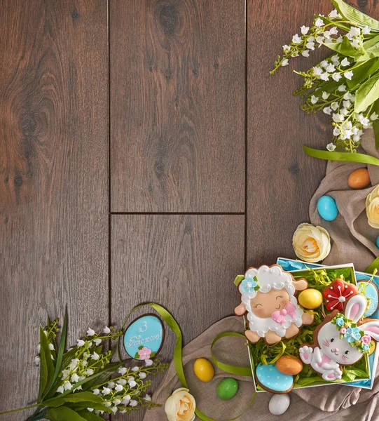 Stylish easter frame made of gingerbread, eggs and flowers