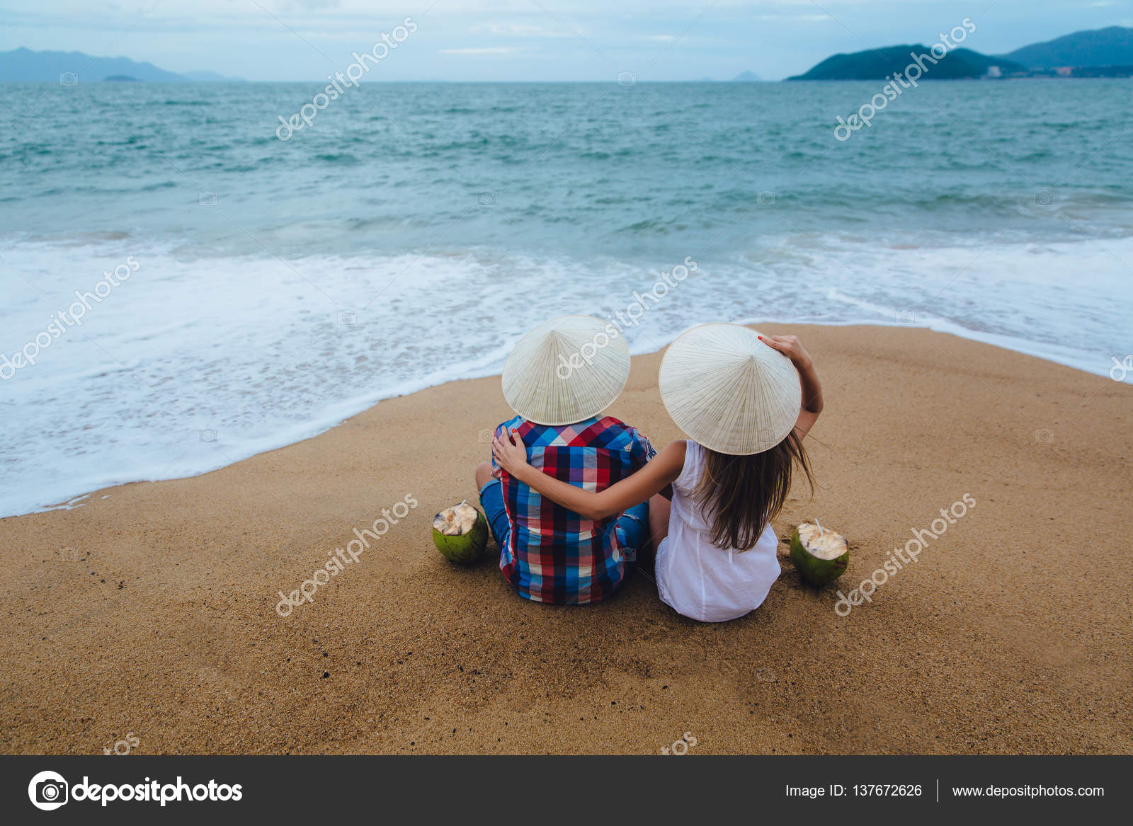 Just Married Couple In Vietnamese Hats Turned Back Sitting On The