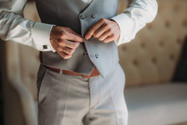 Yakın çekim işadamı damat ceketini giyiyor. Erkekler şık zarif giysiler kavramı