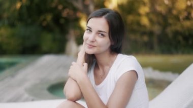 girl with dark loose hair poses for camera at resort villa