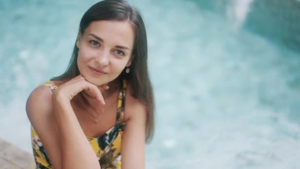 Cheerful woman near swimming pool edge at resort slow motion — Stock video