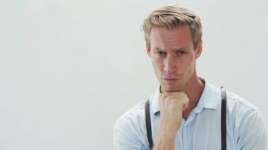 serious man with blue eyes and fair hair looks straight