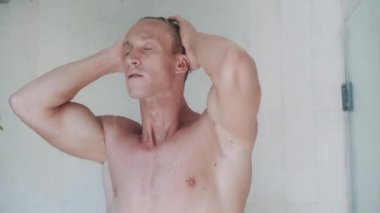 attractive man takes refreshing shower in modern cabin