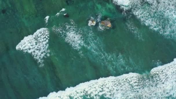 Sharp grey rocks surrounded by boundless ocean waves — Αρχείο Βίντεο