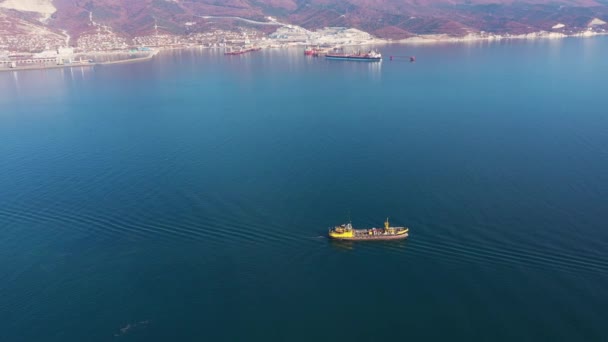 Small cargo ship surrounded by boundless blue calm ocean — Stockvideo