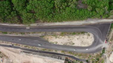 motion above serpentine highway turn with driving cars