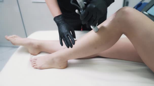 Female beautician is making hair removal procedure using modern laser — Stock Video
