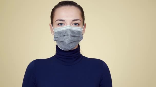 Portrait of woman takes off protective medical mask, breathes deeply and smiles — Stock Video