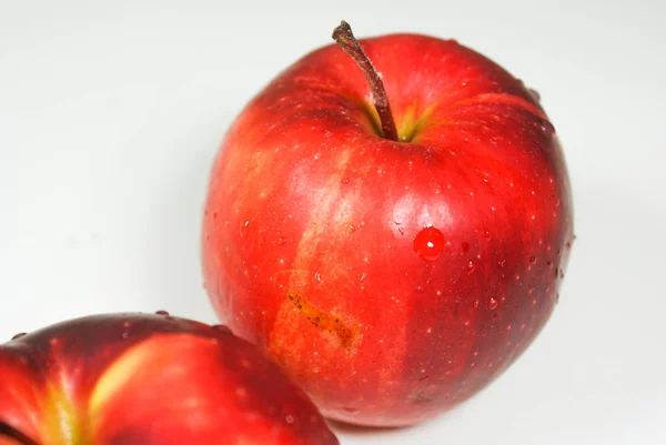 Fresh juicy red apples on a white table — Stock Photo, Image