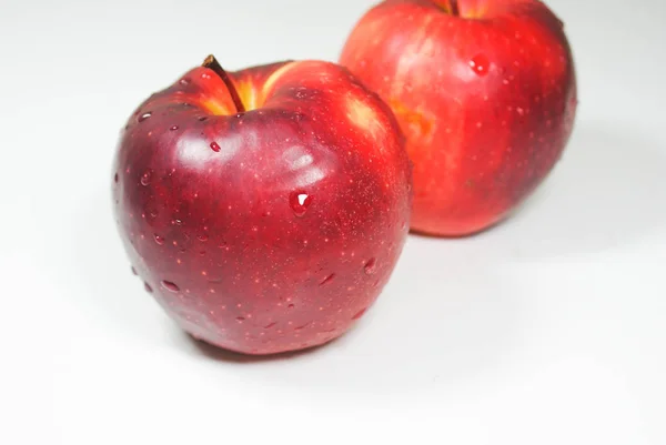 Fresh juicy red apples on a white table — Stock Photo, Image