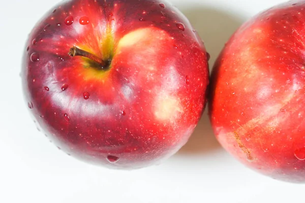 Fresh juicy red apples on a white table — Stock Photo, Image