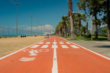 the red Bicycle path in the city of Batumi clipart