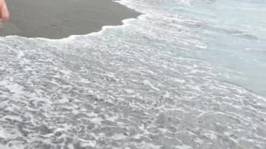 Kumsalda yürüyen kız.