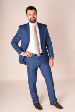 Zarafet ve stil. Smokin ve kırmızı kravat takan yakışıklı genç adam portresi.