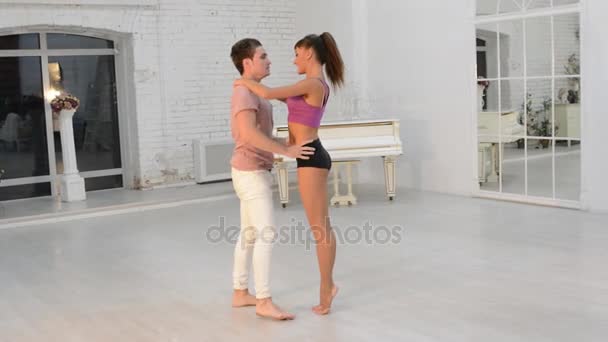 Chica con chico danza danza gimnástica en el salón de baile — Vídeo de stock