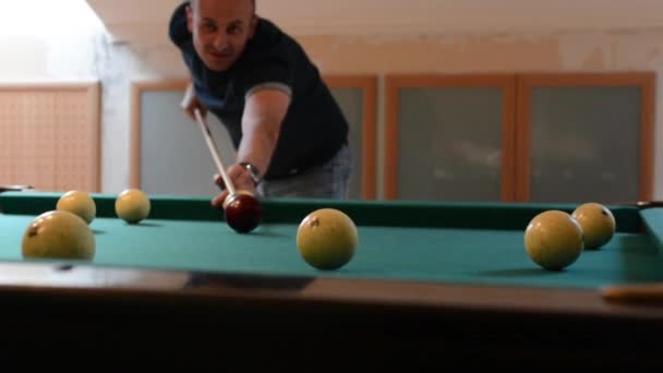 Man in billiards shoots at balls — Stock Video